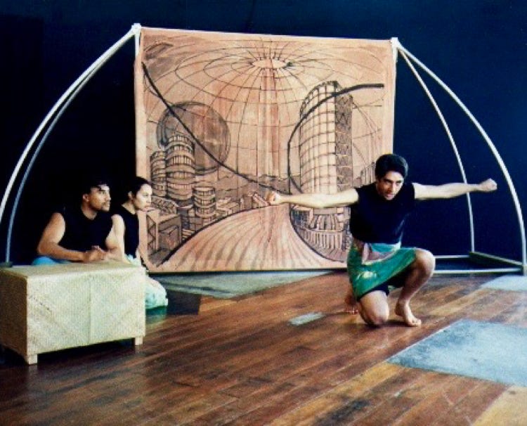 Three Pasifika actors performing physical theatre in front of a futuristic backdrop.