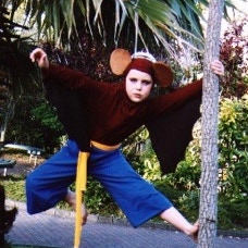 A child costumed as a monkey wearing a crown