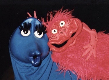 Bluey, a sweet-looking blue puppet with long eyelashes, and Critter, a gnarly bright pink puppet with a wild grin.