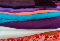 A pile of colourful fabrics for costumes