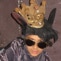 Boy in rat costume with crown and Elvis sunglasses