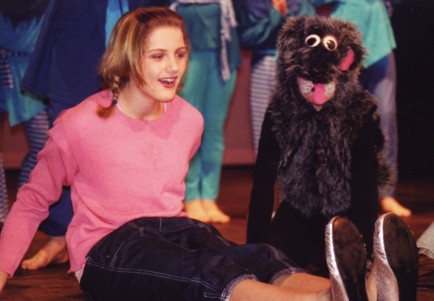 Dorothy and her dog Toto admire the witch's silver shoes