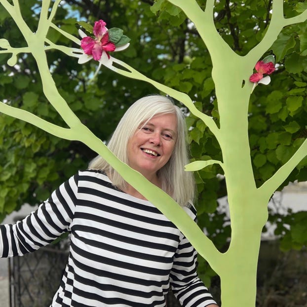 Calico director Jenny Wake with woodland scenery.