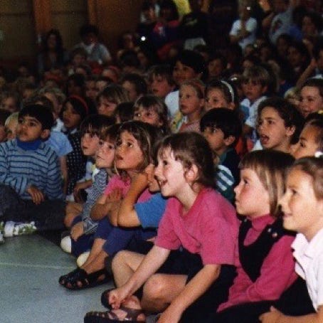 School children watching a Calico show